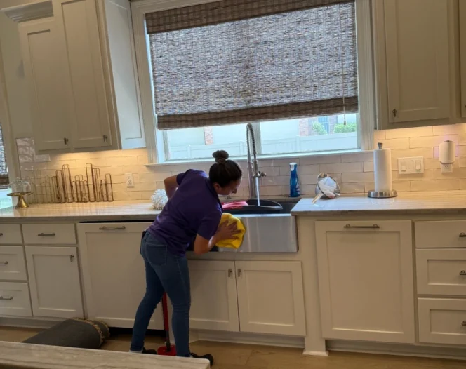 cleaning services worker cleaning kitchen in walker LA home 1
